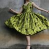 Woman twirling in a vibrant floral dress capturing movement and style.