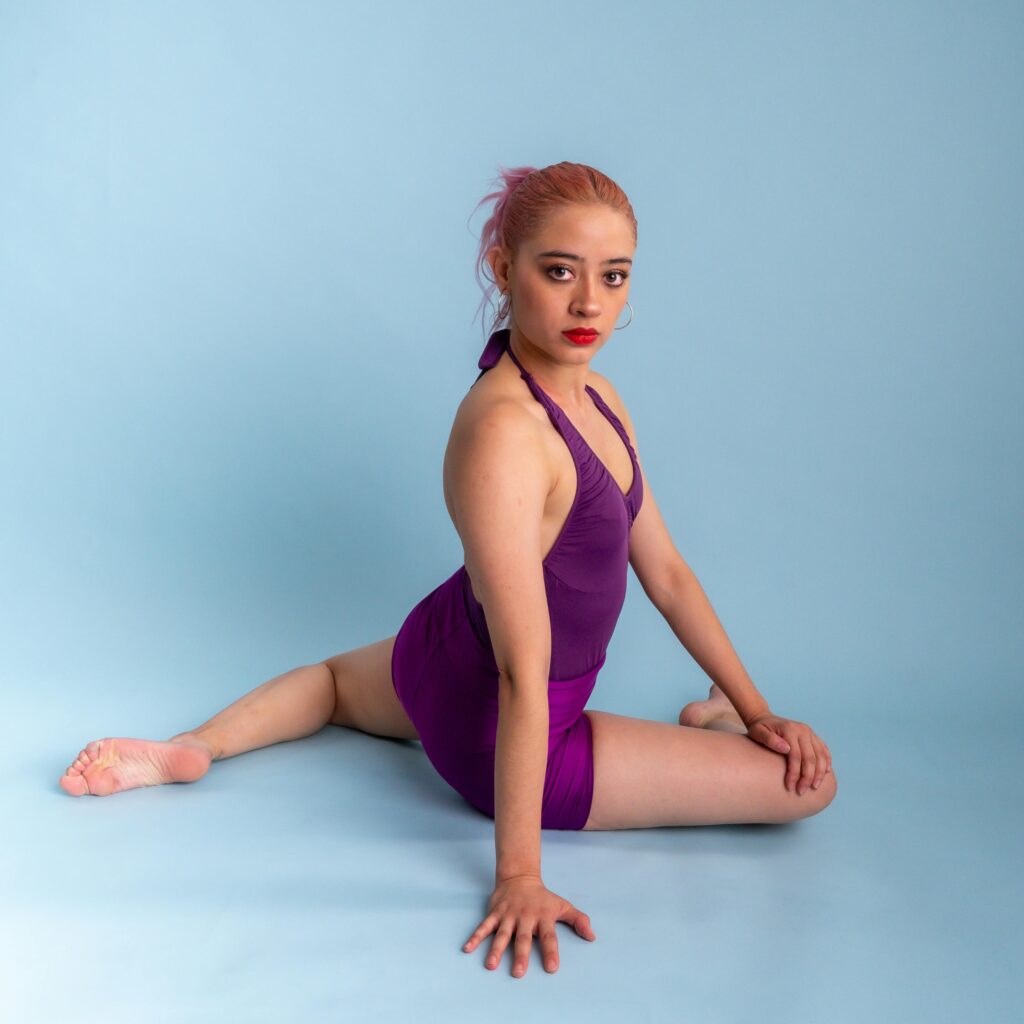 Linktree szablon 1 Ballerina performing a graceful pose in vibrant purple attire in Mexico City studio.